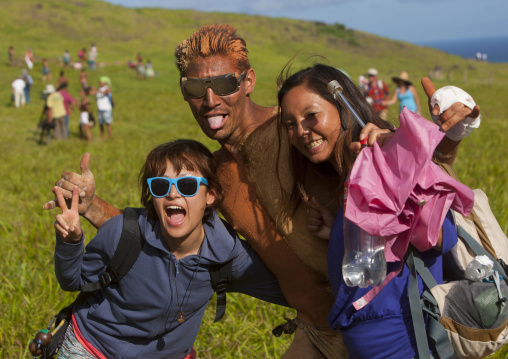 Japanese pausing with a rapanui man after his banana haka pei competition, Easter Island, Hanga Roa, Chile