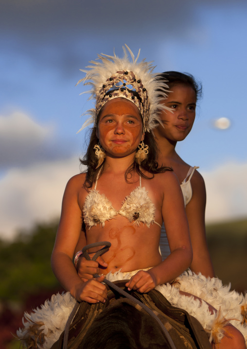 Girls on a horse during tapati festival, Easter Island, Hanga Roa, Chile