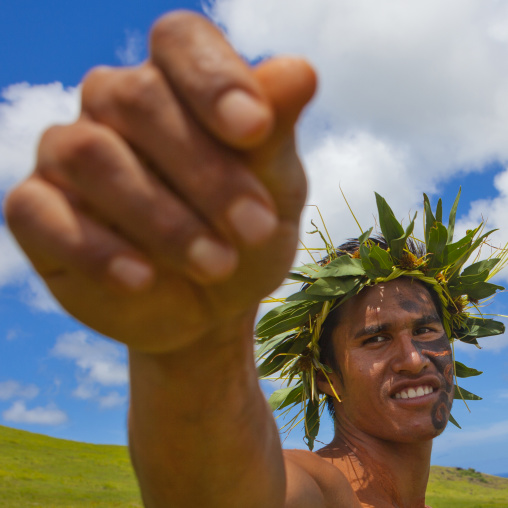 Man with traditional headdress and make up in tapati festival, Easter Island, Hanga Roa, Chile