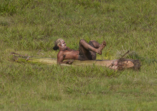 Man on banana trunk during haka pei competition during tapati festival, Easter Island, Hanga Roa, Chile