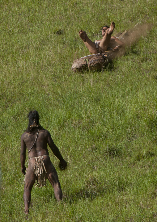 Man on banana trunk during haka pei competition during tapati festival, Easter Island, Hanga Roa, Chile