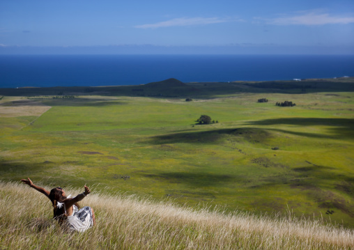 Woman at the top of a hill, Easter Island, Hanga Roa, Chile