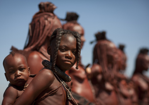 Muhimba Girl Carrying A Baby On Her Back, Village Of Elola, Angola