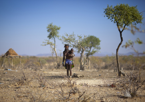 Muhimba Woman Carrying Her Baby Outside Of The Village Of Elola, Angola