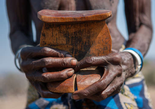 Muhacaona tribe woman holding an old headrest, Cunene Province, Oncocua, Angola