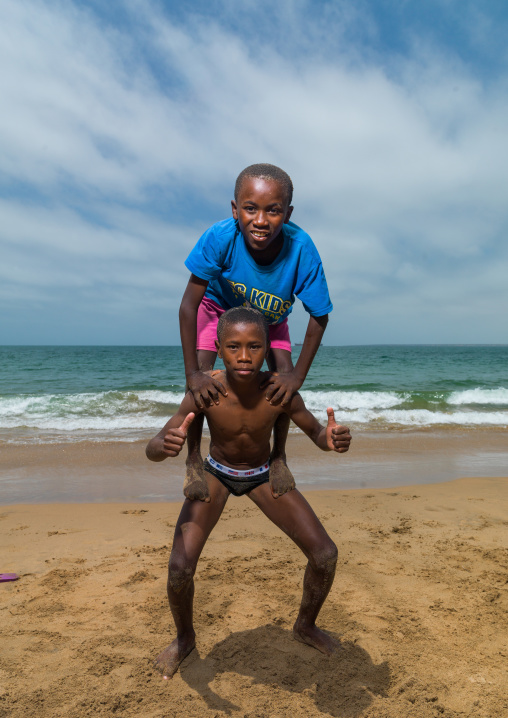 Angolan boys dancing capoeira on the beach, Namibe Province, Namibe, Angola