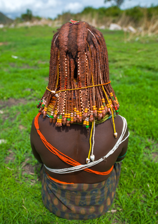 Rear view of a Mumuhuila tribe woman, Huila Province, Chibia, Angola