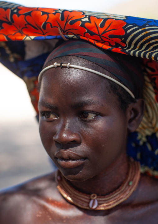 Mucubal tribe woman wearing a colorful headwear, Namibe Province, Virei, Angola