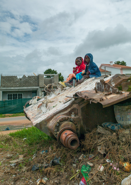 Angolan children playing on a tank wreck, Huambo Province, Huambo, Angola