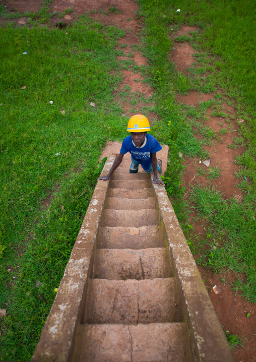 Angolan boy with a yellow safety helmet, Malanje Province, Calandula, Angola