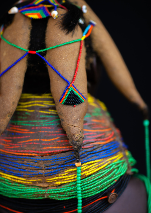 Rear view of a Mumuhuila tribe woman, Huila Province, Chibia, Angola