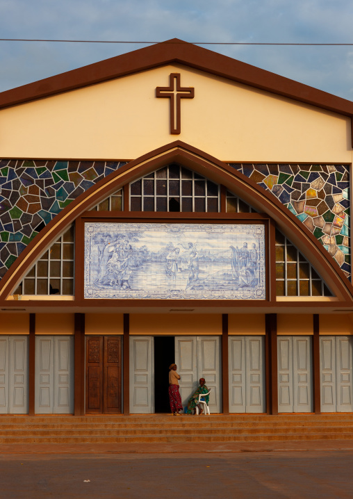 Angolan people sit in front of a church, Cuanza Norte, N'dalatando, Angola