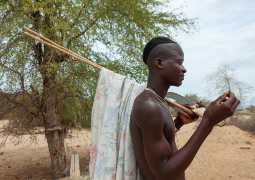 Mucubal tribe man smoking, Namibe Province, Virei, Angola