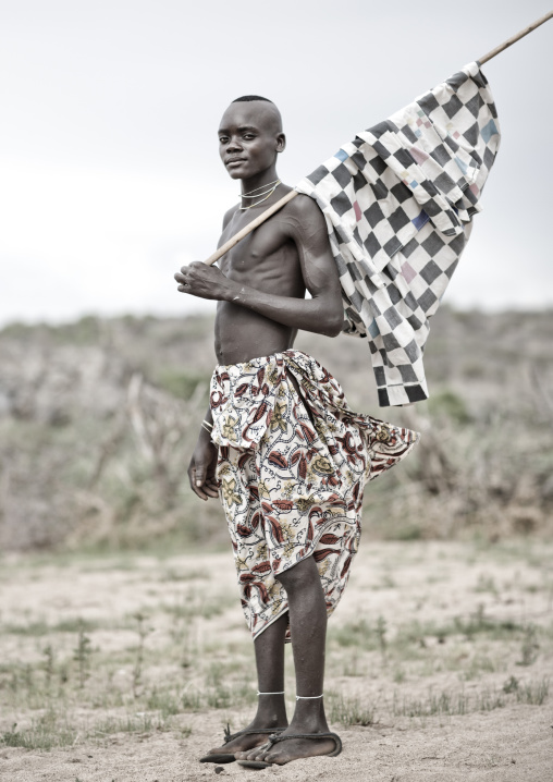 Mukubal Teenage Boy Carrying A Flag, Virie Area, Angola