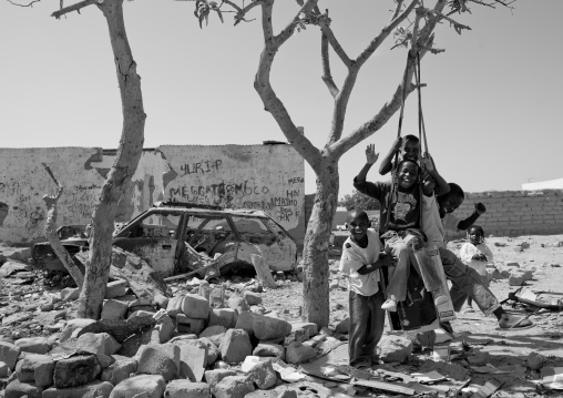 Kids Having Fun On A Swing In The Suburbs Of Namibe Town, Angola