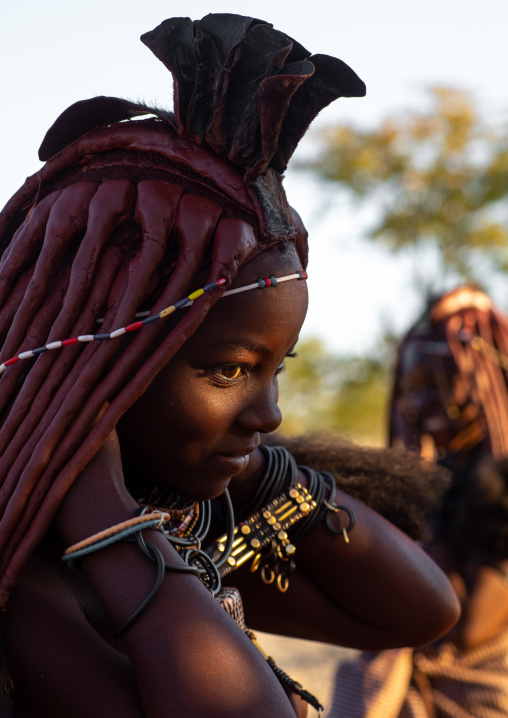 Himba tribe woman with a ray of light on her face, Cunene Province, Oncocua, Angola