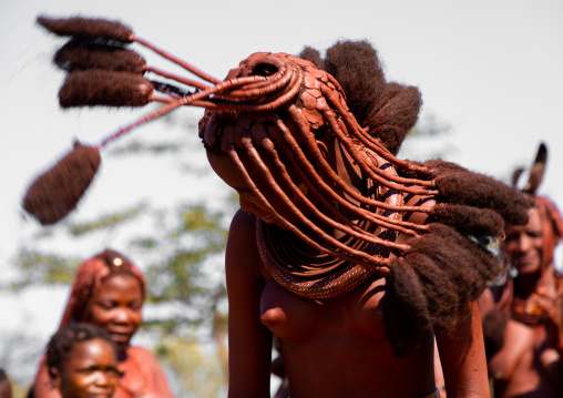 Batwa tribe woman dancing and playing with her dreadlocks, Cunene Province, Oncocua, Angola