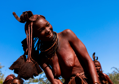 Batwa tribe woman dancing and playing with her dreadlocks, Cunene Province, Oncocua, Angola