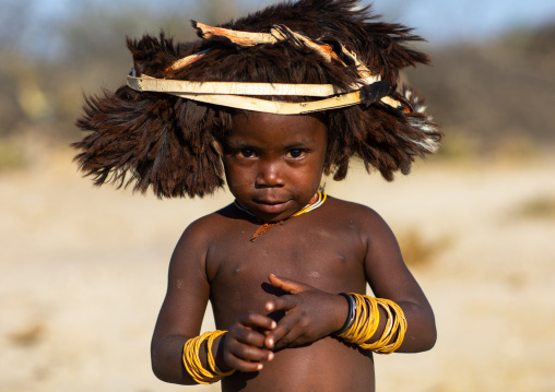 Cute mucubal tribe boy wearing a fur headwear, Namibe Province, Virei, Angola