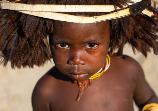 Cute mucubal tribe boy wearing a fur headwear, Namibe Province, Virei, Angola