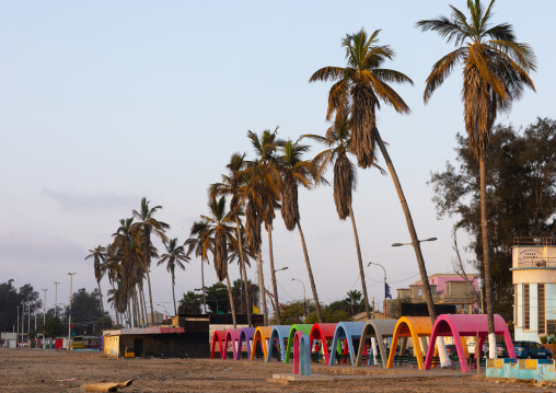 Palm trees and umbreallas on Miragens beach, Namibe Province, Namibe, Angola