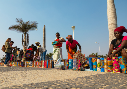 Angolan women selling wax print cloths in a street market, Luanda Province, Luanda, Angola