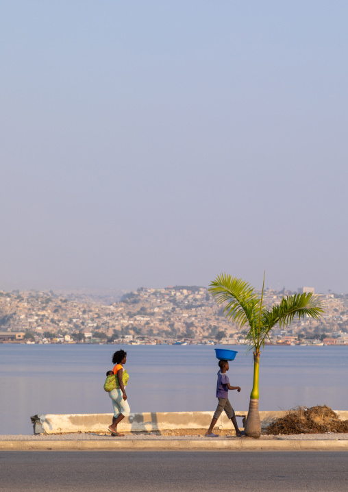 Angolan women walking along the seashore, Benguela Province, Lobito, Angola