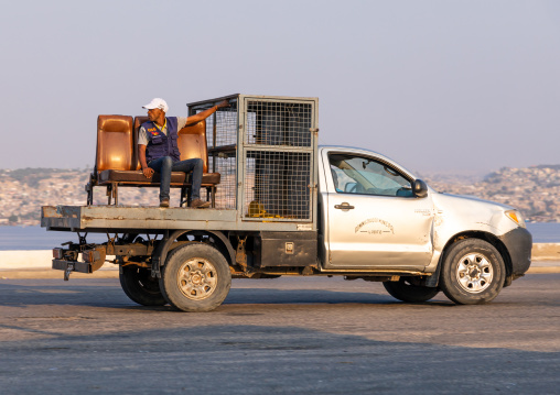 Administration car with a man sit on the back, Benguela Province, Lobito, Angola