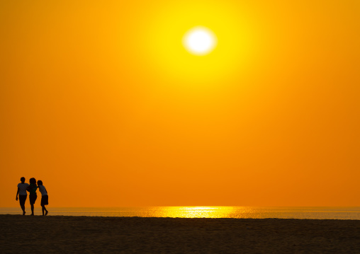 Silhouettes of women at sunset on a beach, Benguela Province, Lobito, Angola