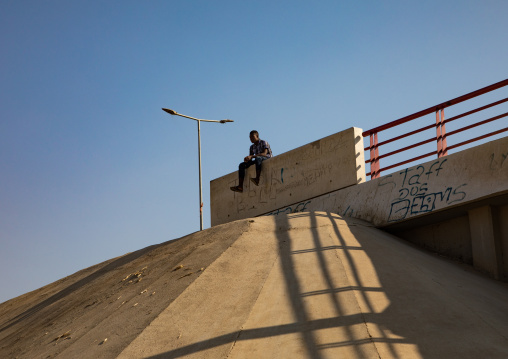 Angola man sit on the side of the road, Benguela Province, Catumbela, Angola