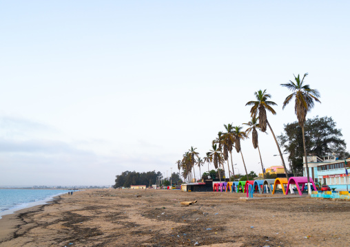 Palm trees and umbreallas on Miragens beach, Namibe Province, Namibe, Angola