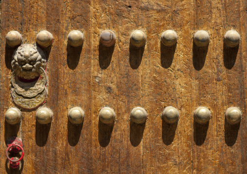 Painted Door With Brass Studs And Door Knocker In Forbidden City, Beijing, China