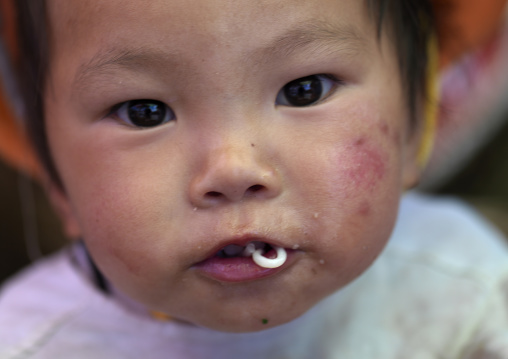 Chinese Baby Eating Noodles, Lijiang, Yunnan Province, China