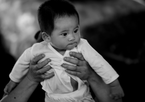 Mother Holding Her Baby, Menglun, Yunnan Province, China