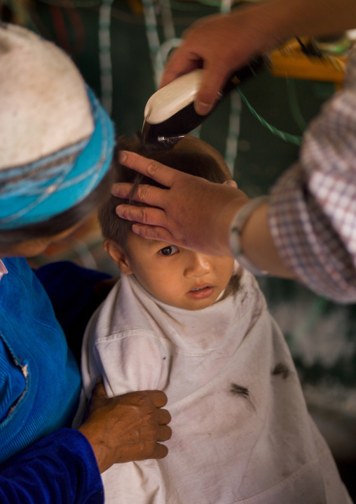 Chinese Kid Having A Haircut, Xizhou, Yunnan Province, China