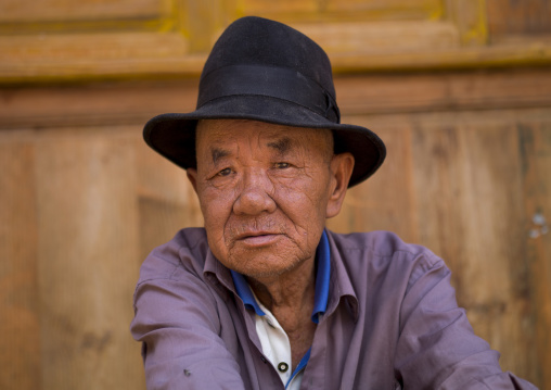 Man Sit In The Street, Bai Village Of Shaxi, Yunnan Province, China