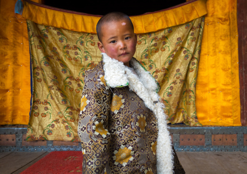 Tibetan child boy in traditional clothing in Shachong monastery, Qinghai Province, Wayaotai, China