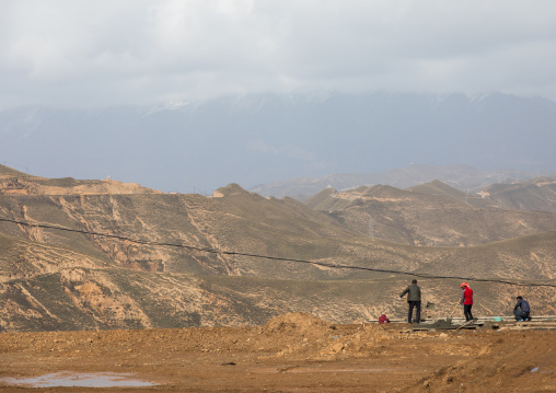 Tibetan workers in a field, Qinghai Province, Wayaotai, China