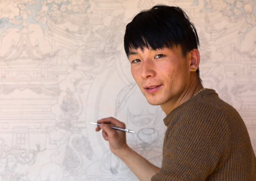 Tibetan artist Sonem Bhum painting a thangka at a workshop, Qinghai province, Wutun, China