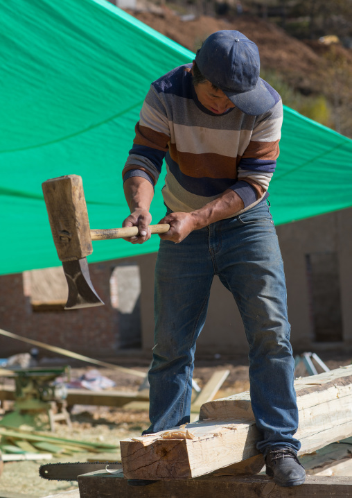 Tibetan carpenters building a new wooden house, Tongren County, Rebkong, China