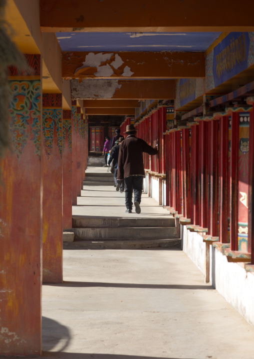 Tibetan pilgrims turning prayer wheels in a Rongwo monastery, Tongren County, Longwu, China