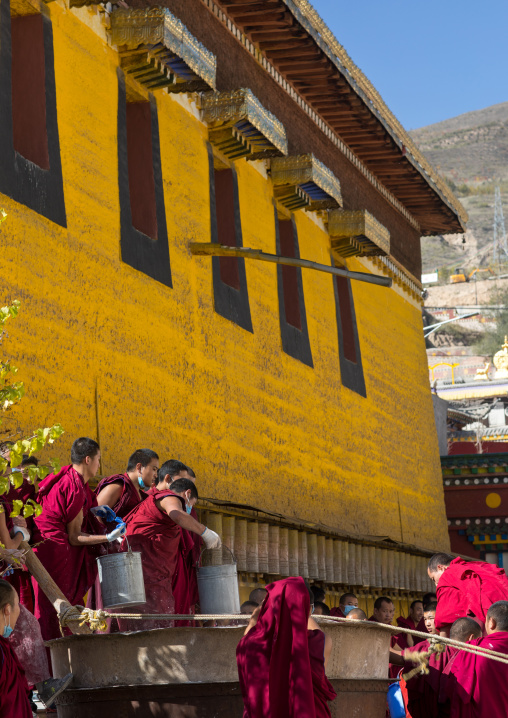 Monks preparing the painting of a temple in Rongwo monastery, Tongren County, Longwu, China