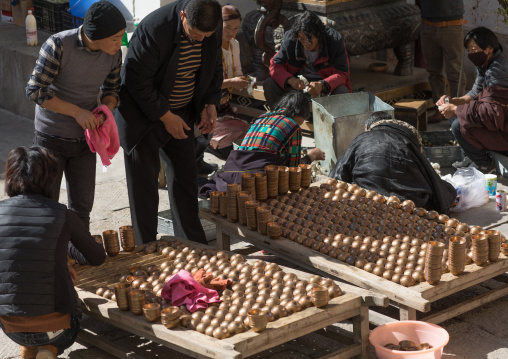 Volunteers cleaning butter lamps in Rongwo monastery, Tongren County, Longwu, China