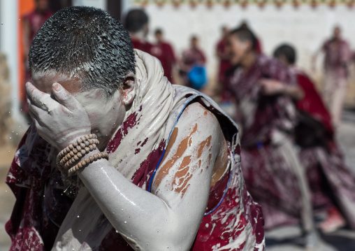 Tibetan monks enjoying a water fight after the yearly renovation of the Rongwo monastery, Tongren County, Longwu, China