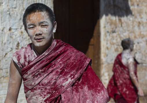 Tibetan monks enjoying a water fight after the yearly renovation of the Rongwo monastery, Tongren County, Longwu, China