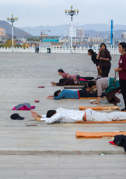 Tibetan pilgrims praying and prostrating in Rongwo monastery, Tongren County, Longwu, China