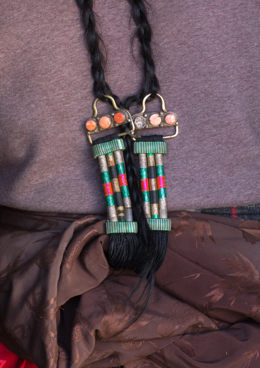 Tibetan nomad woman wearing a plaque in her braided hair, Qinghai province, Tsekhog, China