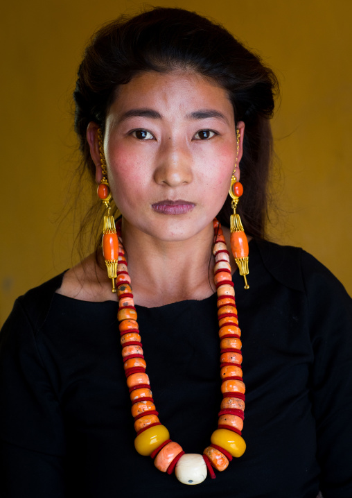 Portrait of a tibetan woman with a huge necklace, Qinghai province, Tsekhog, China