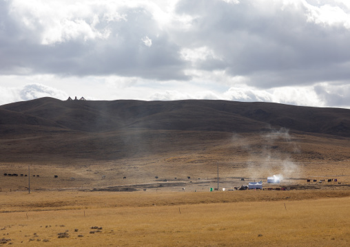 Tibetan nomad family living in a tent in the grasslands, Qinghai province, Tsekhog, China