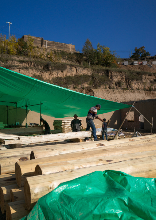 Carpenters building a new wooden house, Tongren County, Rebkong, China